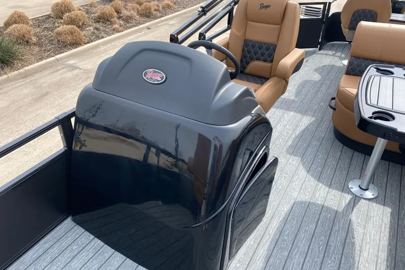Slide: The Image of 2026 Ranger 220F boat interior with tan seating and sleek black console. - 65