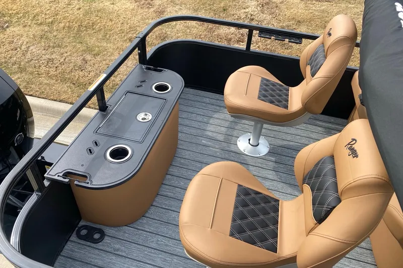 Slide: The Image of 2026 Ranger 220F boat interior with tan seats and a sleek control panel. - 68