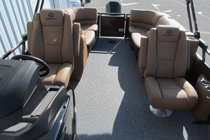 Slide: The Image of 2026 Regency 230 DL boat interior with tan seating and modern design. - 12