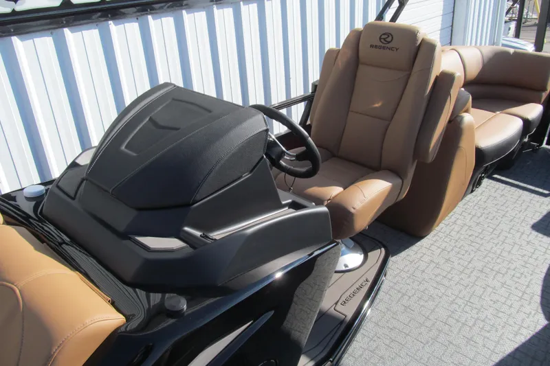 Slide: The Image of 2026 Regency 230 DL boat interior with tan leather seating and modern helm. - 14