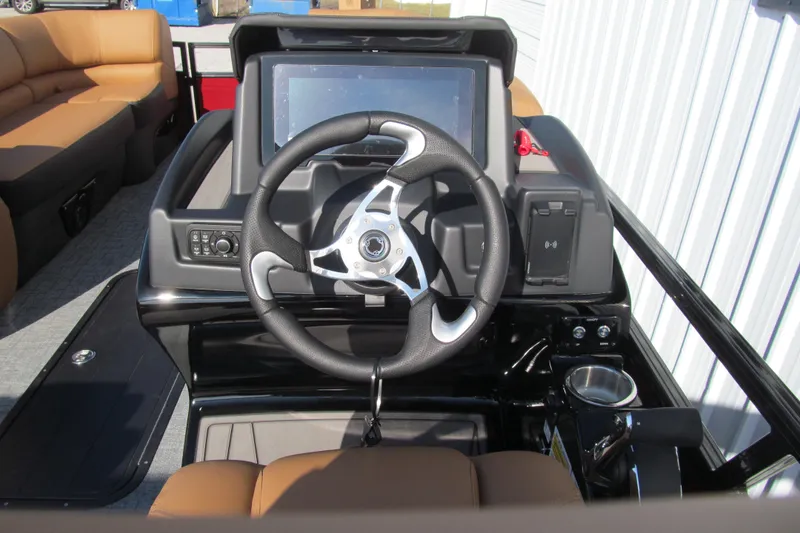 Slide: The Image of 2026 Regency 230 DL boat dashboard with steering wheel and touchscreen display. - 7