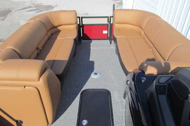 Slide: The Image of 2026 Regency 230 DL boat interior with tan seating and gray flooring. - 9
