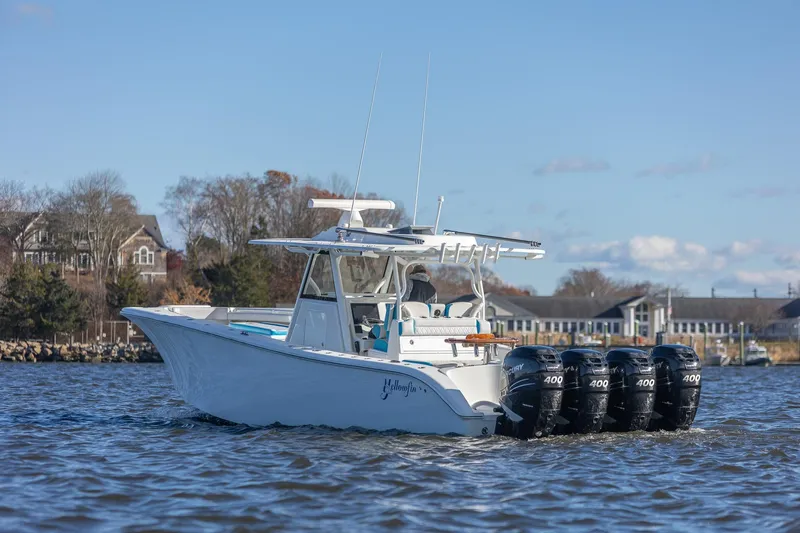 Slide: The Image of 2018 Yellowfin 39 Offshore boat with four powerful engines on a calm waterway. - 15