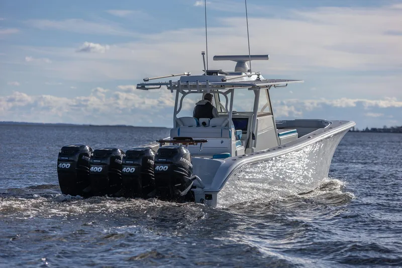 Slide: The Image of 2018 Yellowfin 39 Offshore boat with four powerful outboard engines cruising on open water. - 18