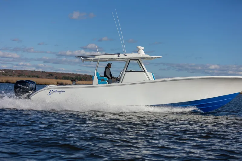 Slide: The Image of 2018 Yellowfin 39 Offshore boat cruising on open water under clear blue sky. - 21