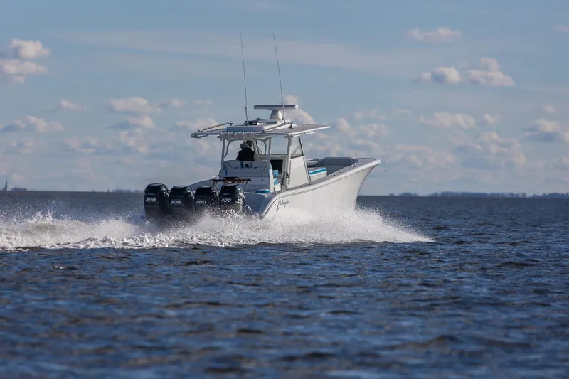 Slide: The Image of 2018 Yellowfin 39 Offshore boat cruising on open water under a clear sky. - 26