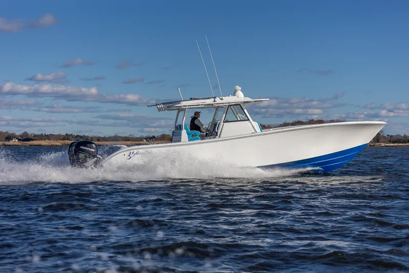 Slide: The Image of 2018 Yellowfin 39 Offshore boat cruising on open water under clear blue sky. - 35
