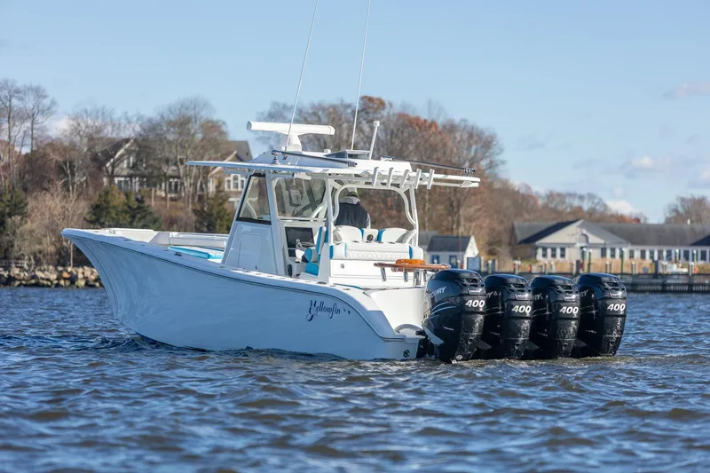 Slide: The Image of 2018 Yellowfin 39 Offshore boat with four powerful outboard engines on a calm waterway. - 4