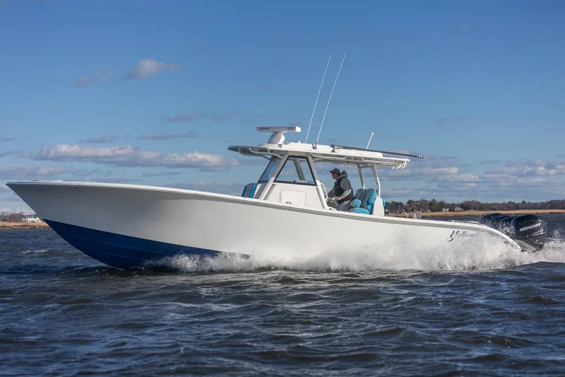 Slide: The Image of 2018 Yellowfin 39 Offshore boat cruising on open water under clear blue sky. - 44