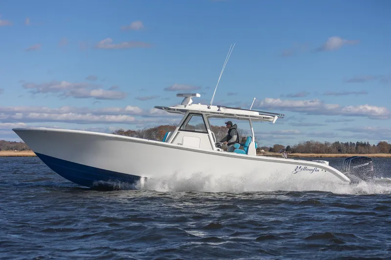 Slide: The Image of 2018 Yellowfin 39 Offshore boat cruising on open water under a clear blue sky. - 45