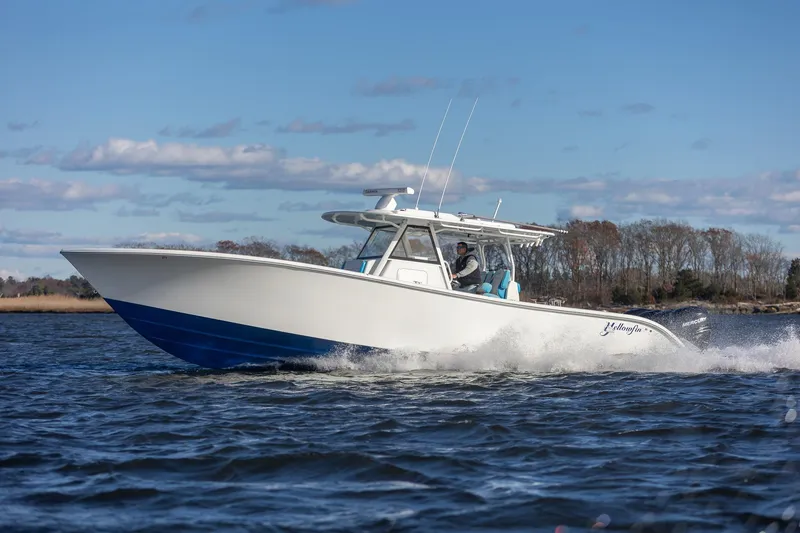 Slide: The Image of 2018 Yellowfin 39 Offshore boat cruising on open water under a clear sky. - 47