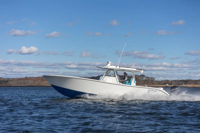 Slide: The Image of 2018 Yellowfin 39 Offshore boat cruising on open water under a clear blue sky. - 48