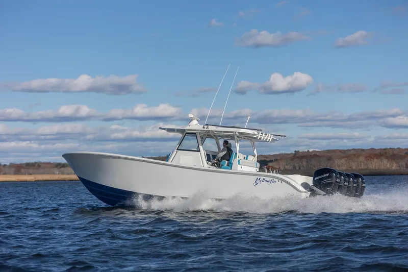 Slide: The Image of 2018 Yellowfin 39 Offshore boat cruising on open water under a clear blue sky. - 50