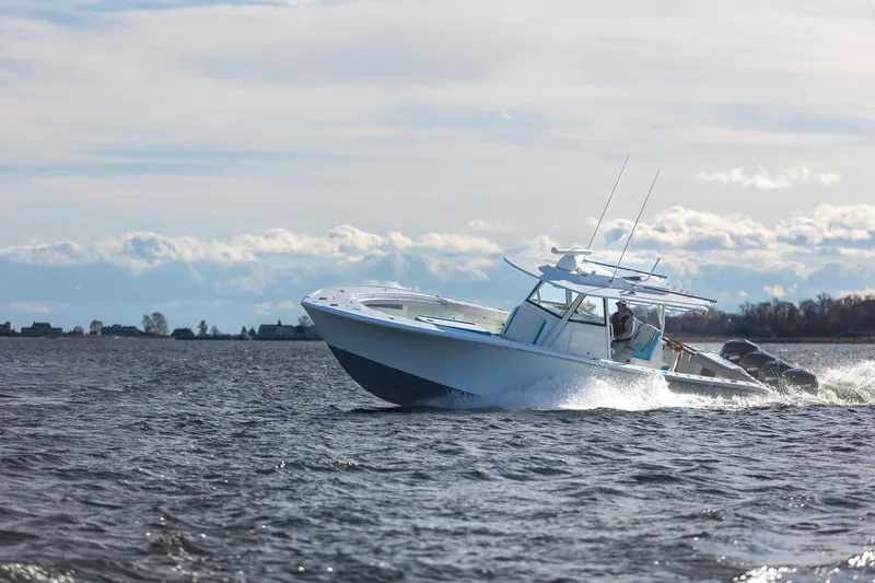 Slide: The Image of 2018 Yellowfin 39 Offshore boat cruising on open water under cloudy sky. - 54