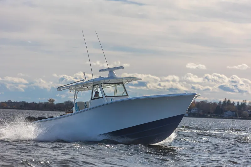 Slide: The Image of 2018 Yellowfin 39 Offshore boat cruising on open water under a cloudy sky. - 58