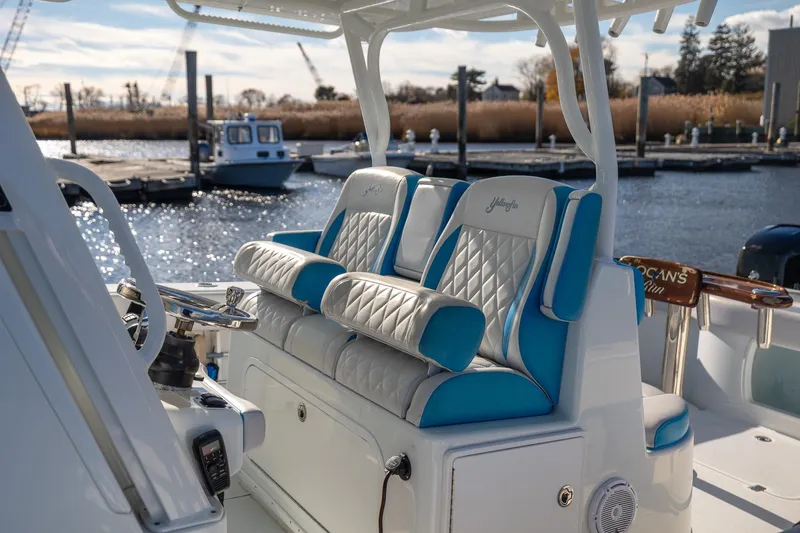 Slide: The Image of 2018 Yellowfin 39 Offshore boat with luxurious blue and white seating at a marina. - 6