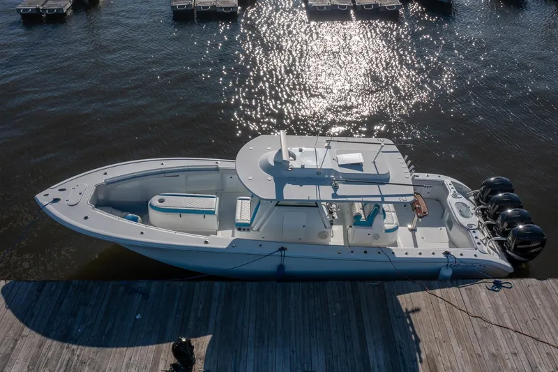 Slide: The Image of 2018 Yellowfin 39 Offshore boat docked, featuring sleek design and powerful engines. - 64