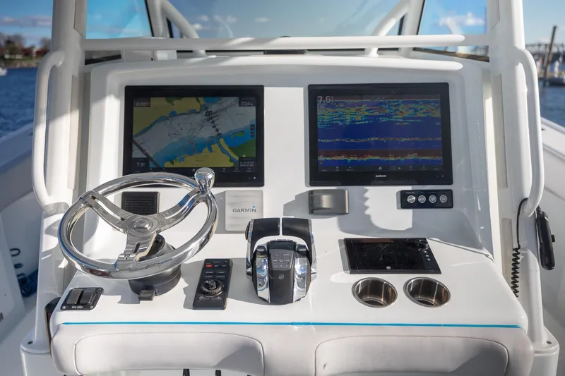Slide: The Image of 2018 Yellowfin 39 Offshore helm with dual Garmin displays and modern controls. - 7