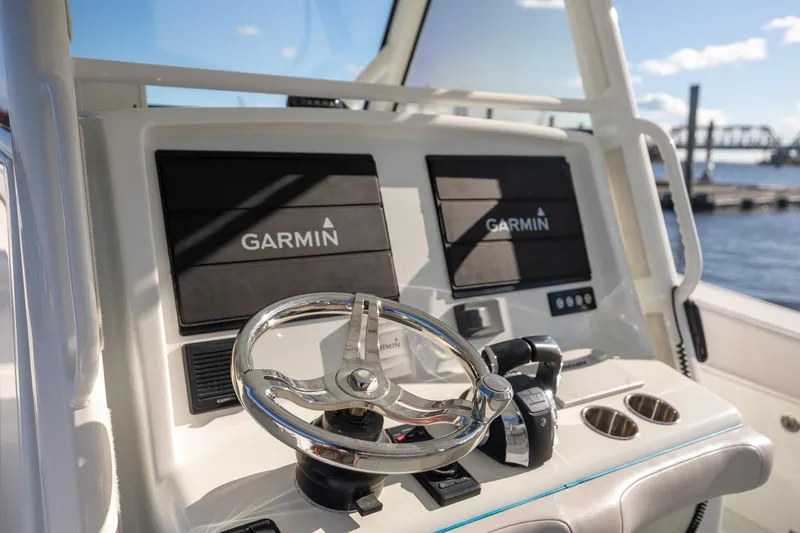 Slide: The Image of 2018 Yellowfin 39 Offshore boat dashboard with Garmin navigation system and steering wheel. - 8
