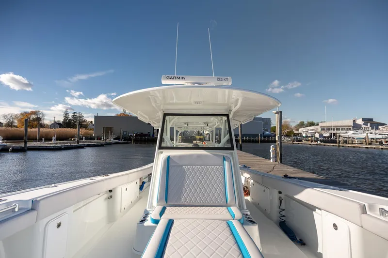 Slide: The Image of 2018 Yellowfin 39 Offshore boat docked, featuring spacious seating and clear skies. - 9