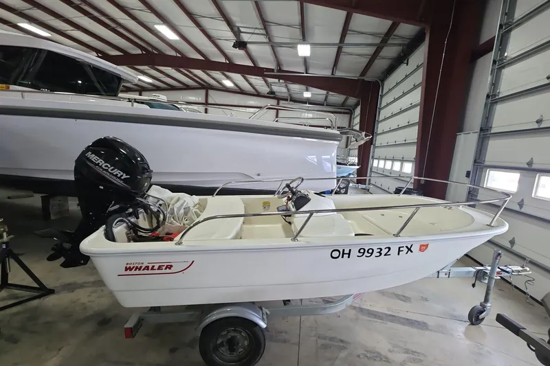 The Image of 2020 Boston Whaler 110 Sport boat with Mercury engine in a storage facility. - 0