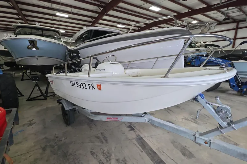 Slide: The Image of 2020 Boston Whaler 110 Sport boat on trailer in indoor storage facility. - 1