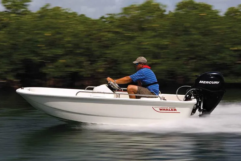 Slide: The Image of Manufacturer Provided Image: 2020 Boston Whaler 110 Sport boat speeding on water with Mercury outboard motor. - 11