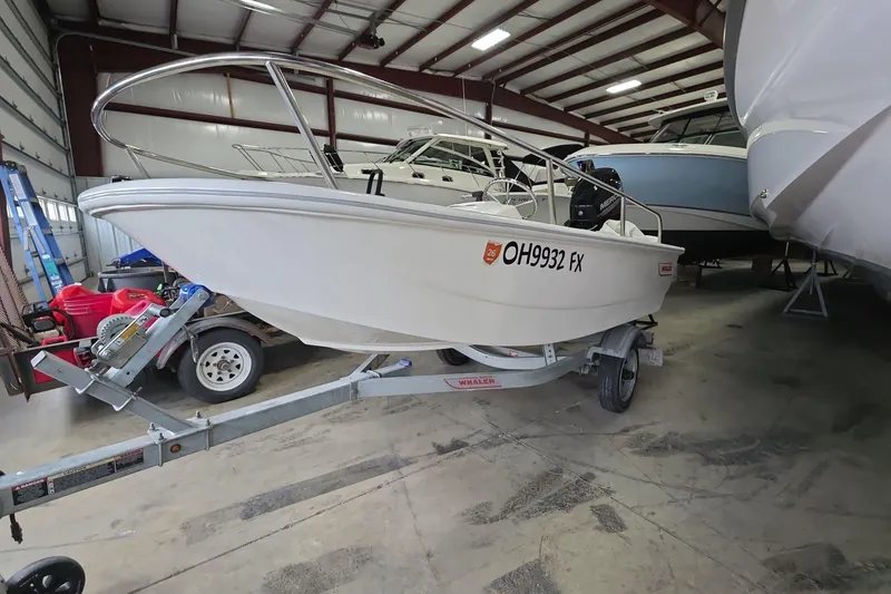 Slide: The Image of 2020 Boston Whaler 110 Sport boat on trailer in indoor storage facility. - 2