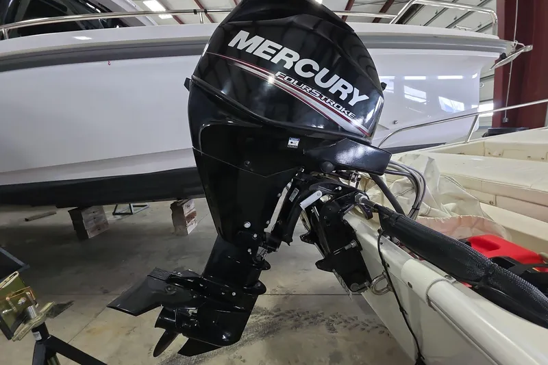 Slide: The Image of 2020 Boston Whaler 110 Sport with Mercury FourStroke outboard engine in a garage. - 5
