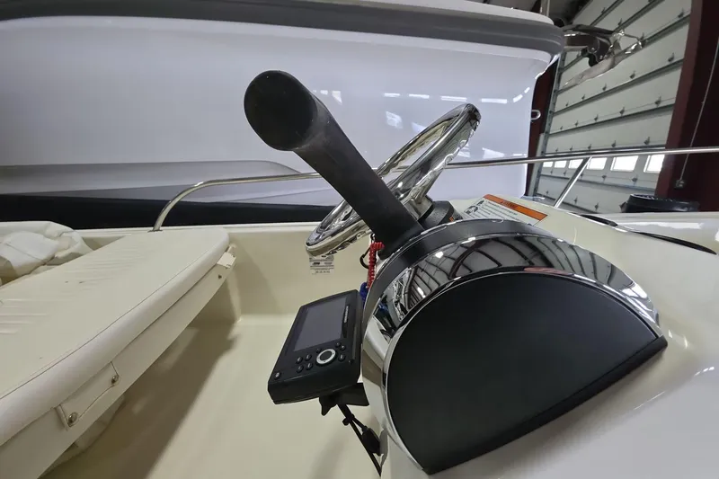 Slide: The Image of 2020 Boston Whaler 110 Sport boat interior with steering wheel and control panel. - 8