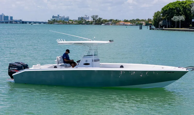 Slide: The Image of A 1999 Monza 31 boat on calm water with city skyline in the background. - 10