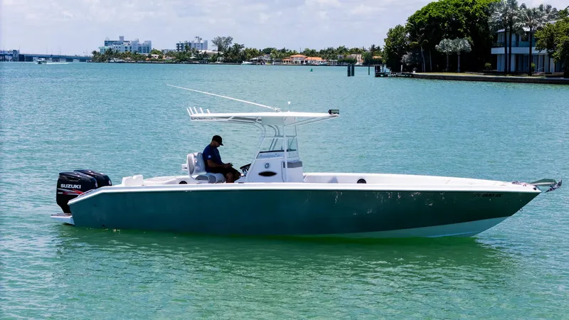 Slide: The Image of 1999 Monza 31 boat on calm water with Suzuki outboard motor. - 11