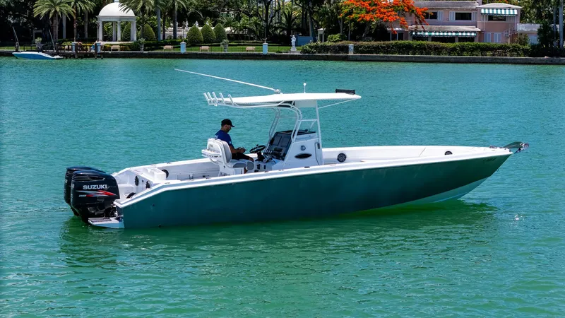 Slide: The Image of A 1999 Monza 31 boat with Suzuki engine on turquoise water. - 12