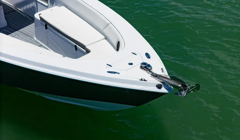 Slide: The Image of Bow of a 1999 Monza 31 boat on green water, featuring anchor and seating area. - 17