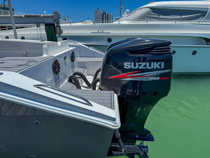 Slide: The Image of Monza 31 boat with Suzuki four-stroke engine, docked in marina, 1999 model. - 25