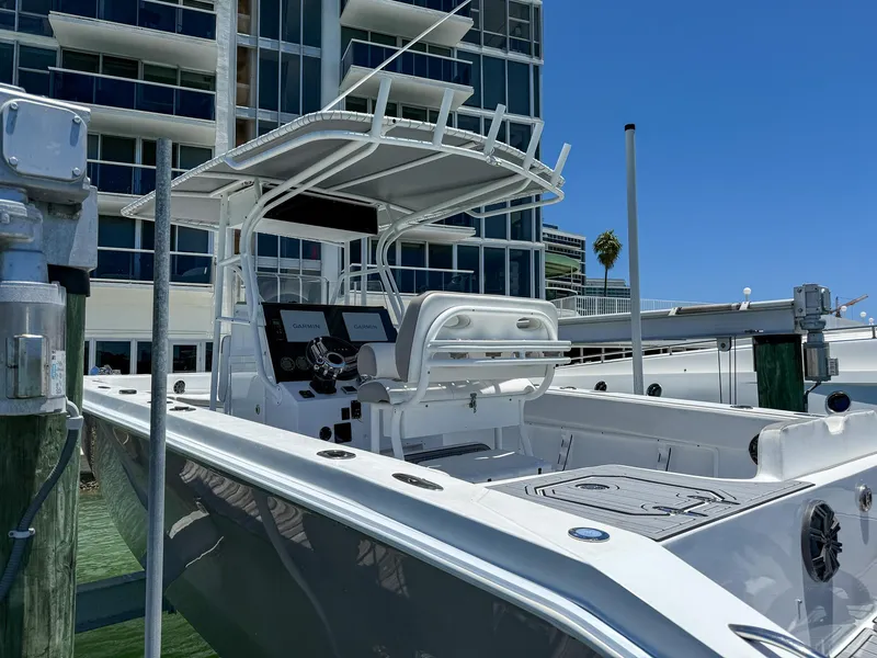 Slide: The Image of 1999 Monza 31 boat docked near modern building, clear blue sky background. - 26