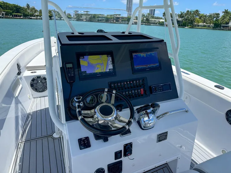 Slide: The Image of Control panel of a 1999 Monza 31 boat with navigation screens and steering wheel. - 29