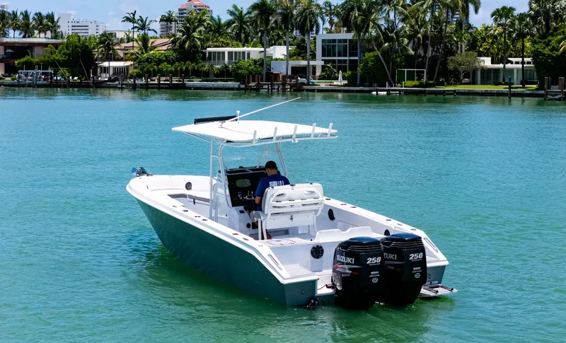 Slide: The Image of A 1999 Monza 31 boat with dual Suzuki 250 engines on clear water. - 3