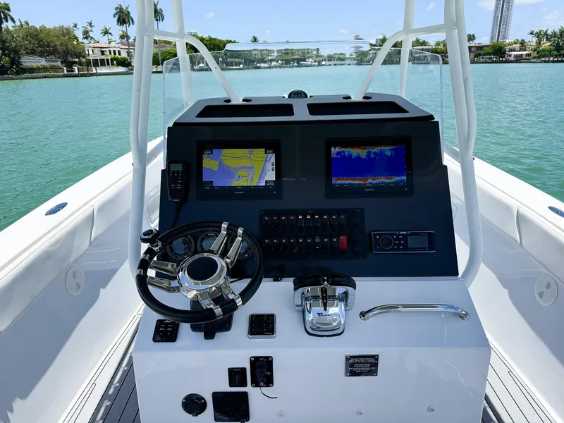 Slide: The Image of Cockpit of a 1999 Monza 31 boat with navigation screens and steering wheel. - 30