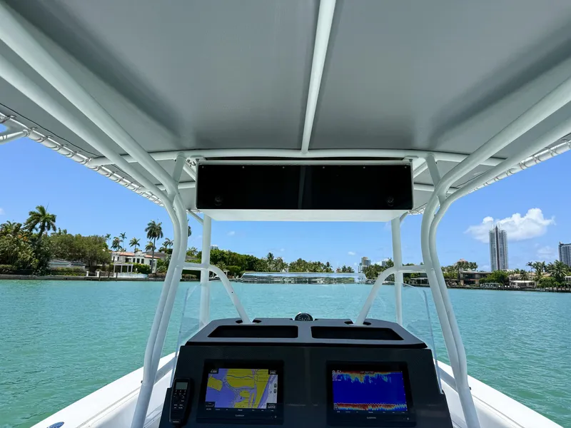 Slide: The Image of View from a 1999 Monza 31 boat cockpit, featuring navigation screens and a scenic waterfront. - 31