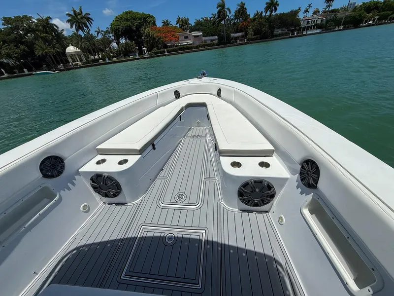 Slide: The Image of Bow view of 1999 Monza 31 boat with seating and speakers on a sunny day. - 32