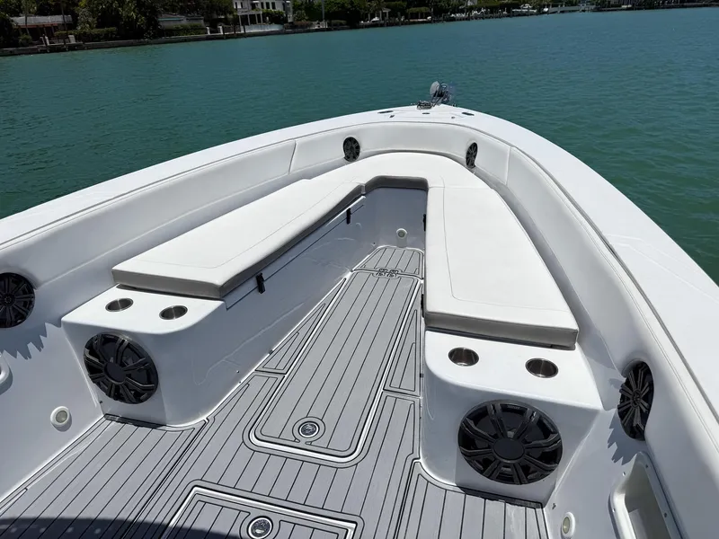 Slide: The Image of 1999 Monza 31 boat interior with white seating, cup holders, and speakers on a calm lake. - 33