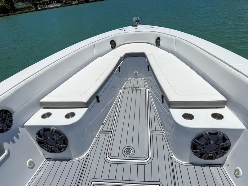 Slide: The Image of Bow seating area of a 1999 Monza 31 boat with cushioned benches and cup holders. - 34