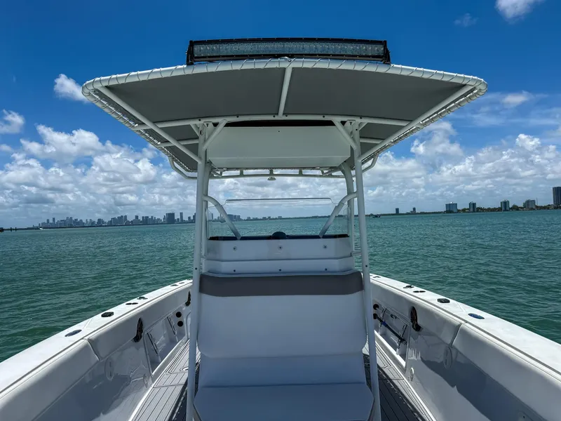 Slide: The Image of Front view of a 1999 Monza 31 boat on open water with city skyline. - 36