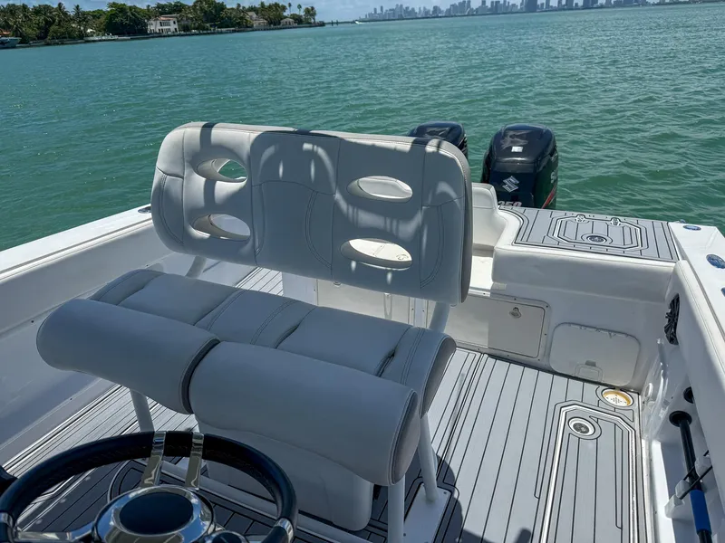 Slide: The Image of 1999 Monza 31 boat interior with dual seats, steering wheel, and ocean view. - 37