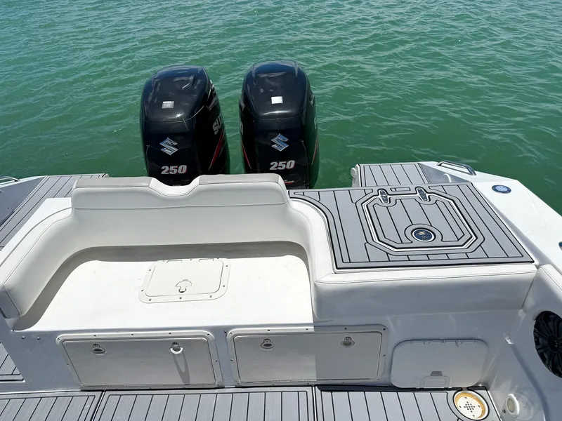 Slide: The Image of 1999 Monza 31 boat with dual Suzuki 250 outboard engines on calm water. - 38