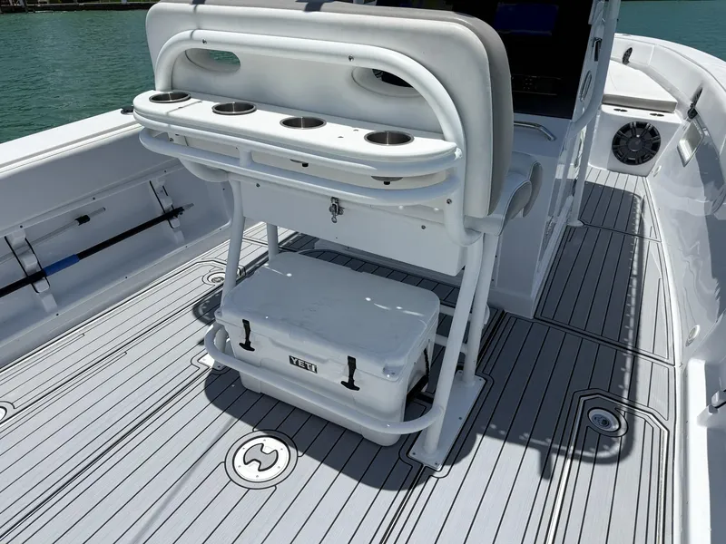 Slide: The Image of 1999 Monza 31 boat interior with seating, rod holders, and Yeti cooler on deck. - 41