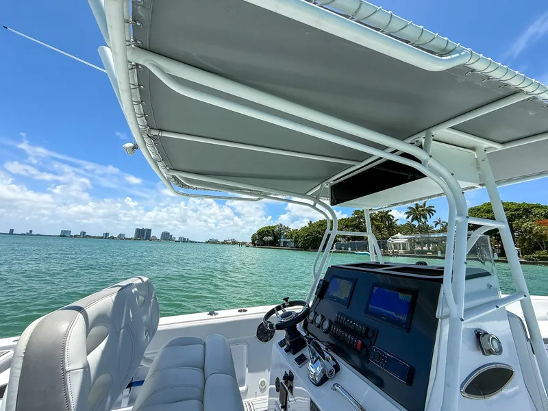 Slide: The Image of 1999 Monza 31 boat interior with steering console, overlooking a scenic waterfront view. - 46