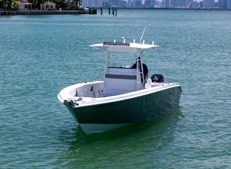 Slide: The Image of A 1999 Monza 31 boat on calm turquoise water with a person onboard. - 6
