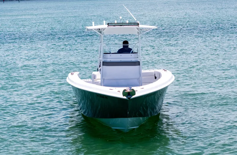 Slide: The Image of A 1999 Monza 31 boat on calm water with city skyline in the background. - 7